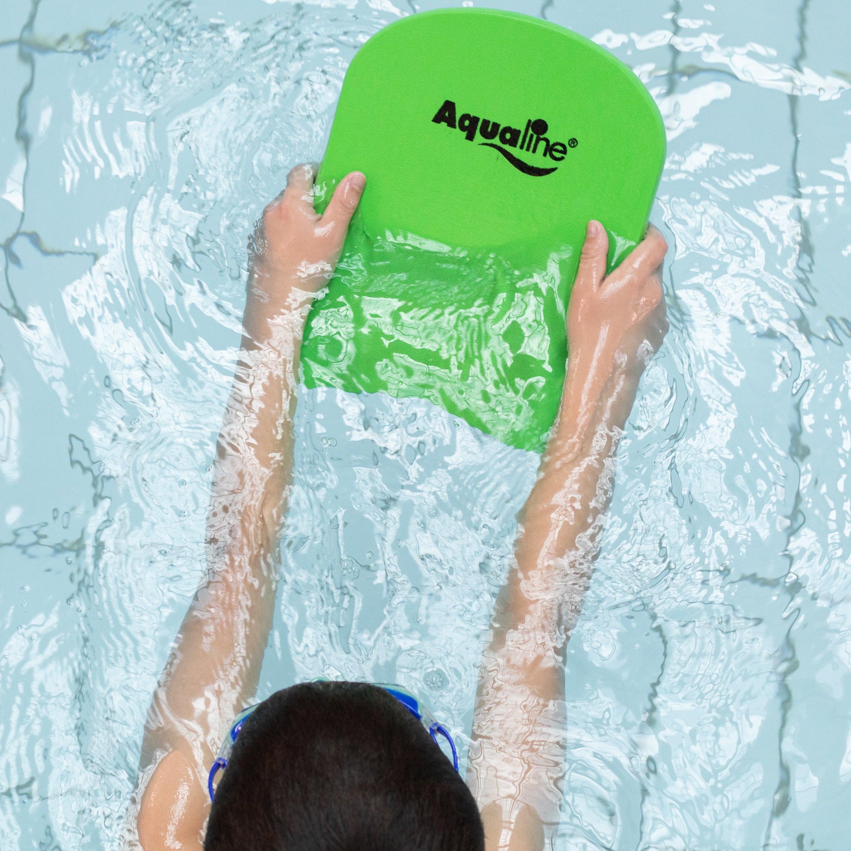 Kid holding a green Aqualine kick board in water